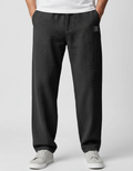 Men's casual trousers in black with relaxed fit and button-zip fastening, front view